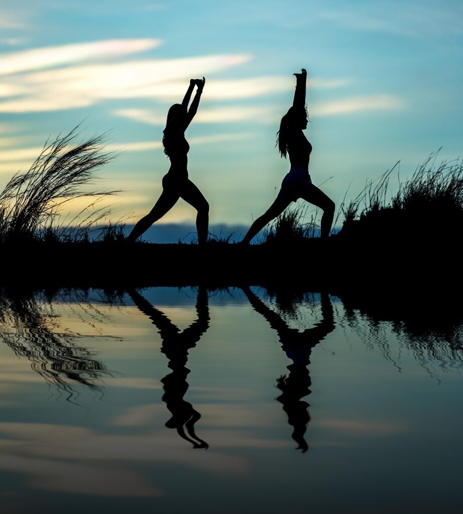 women, yoga, silhouettes, water, reflection, mirroring, water reflection, pose, posing, yoga pose, meditation, stretching, wellness, well-being, exercise, adults, asia, girls, morning, outdoors, pair, people, stance, sunrise, nature, sunset